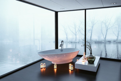 Stunning modern bathroom with panoramic wrap around view windows overlooking a tranquil winter lake and a freestanding boat-shaped tub surrounded by burning candles, 3d rendering corner perspective